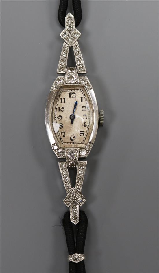 A ladys Art Deco platinum and diamond-set cocktail watch, having Arabic dial, on black cord bracelet with white gold clasp.